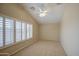 This is a cozy bedroom with carpet, a ceiling fan, and a window with plantation shutters at 1143 S Annie Ln, Gilbert, AZ 85296