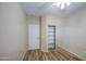 This is a simple bedroom with wood floors and a closet with sliding mirrored doors at 1143 S Annie Ln, Gilbert, AZ 85296