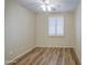 A cozy bedroom with wood floors, neutral walls, and a window with plantation shutters at 1143 S Annie Ln, Gilbert, AZ 85296