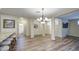 Open-concept living space with dining area featuring stylish lighting and access to other rooms at 1143 S Annie Ln, Gilbert, AZ 85296