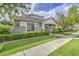 Well-maintained home features manicured landscaping, charming stone accents, and a covered porch at 1143 S Annie Ln, Gilbert, AZ 85296
