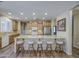 Bright kitchen features stainless steel appliances, granite countertops, and seating at the large island at 1143 S Annie Ln, Gilbert, AZ 85296