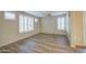 An airy living room with beautiful wood floors and lots of natural light from shuttered windows at 1143 S Annie Ln, Gilbert, AZ 85296