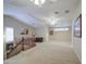 This is a spacious loft area with plush carpeting and staircase with wood railing at 1143 S Annie Ln, Gilbert, AZ 85296