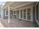 An inviting covered patio featuring a brick-paved floor and seating area at 1143 S Annie Ln, Gilbert, AZ 85296