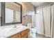 Bathroom with wood vanity, framed mirror, and shower and tub combo at 120 N Pottebaum Rd, Casa Grande, AZ 85122
