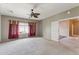 Bedroom features neutral carpet and a ceiling fan at 120 N Pottebaum Rd, Casa Grande, AZ 85122