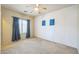 Bedroom featuring neutral carpet, ceiling fan, window with curtains and natural light at 120 N Pottebaum Rd, Casa Grande, AZ 85122