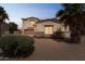 Home featuring desert landscaping, a stone facade, and mature palm trees in the front yard at 120 N Pottebaum Rd, Casa Grande, AZ 85122