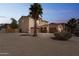 Spacious two-story home featuring a three-car garage, desert landscaping, and a mature palm tree at 120 N Pottebaum Rd, Casa Grande, AZ 85122