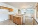 Kitchen featuring tiled floors, wooden cabinets, and a large island for additional counter space at 120 N Pottebaum Rd, Casa Grande, AZ 85122