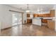 Eat-in kitchen features tiled floors, wood cabinetry, and a sliding door to the backyard at 120 N Pottebaum Rd, Casa Grande, AZ 85122