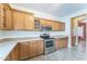 Kitchen features plenty of wooden cabinets, tiled floors, stainless steel appliances, and lots of counter space at 120 N Pottebaum Rd, Casa Grande, AZ 85122