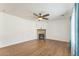 Bright living room with wood flooring and a stone fireplace at 120 N Pottebaum Rd, Casa Grande, AZ 85122