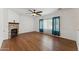 Open-concept living room boasts hardwood floors, fireplace, and natural light at 120 N Pottebaum Rd, Casa Grande, AZ 85122