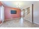Open living room featuring neutral tile flooring and flat screen tv at 120 N Pottebaum Rd, Casa Grande, AZ 85122