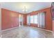 Living room with tiled floors, warm paint, a window with coverings, and an entryway to the bathroom at 120 N Pottebaum Rd, Casa Grande, AZ 85122