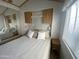 Well-lit bedroom with a queen bed, a large mirror, and built-in cabinets providing ample storage at 1226 S Seneca Dr, Apache Junction, AZ 85119