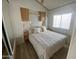 Cozy bedroom featuring a queen-sized bed, built-in cabinets, and soft natural light from the window at 1226 S Seneca Dr, Apache Junction, AZ 85119