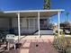 Charming mobile home with a cozy porch and well-kept landscaping in a desirable neighborhood at 1226 S Seneca Dr, Apache Junction, AZ 85119