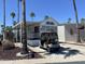 This lovely home is conveniently located with a golf cart and beautiful palm trees at 1226 S Seneca Dr, Apache Junction, AZ 85119