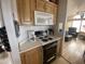 Practical kitchen featuring a stove, microwave, and open layout to the living spaces for easy interaction at 1226 S Seneca Dr, Apache Junction, AZ 85119