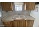Well-maintained kitchen with a double basin sink and oak cabinets for an easy living experience at 1226 S Seneca Dr, Apache Junction, AZ 85119