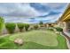 Beautiful backyard featuring a putting green, built-in grill and plenty of space for entertaining at 13353 W Gloria Ln, Peoria, AZ 85383