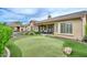 Lush backyard featuring a manicured putting green, elegant patio, and privacy landscaping, ideal for relaxation and entertainment at 13353 W Gloria Ln, Peoria, AZ 85383
