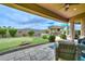 Backyard oasis with a putting green, outdoor kitchen, comfortable seating, and desert landscaping, perfect for relaxation and entertaining at 13353 W Gloria Ln, Peoria, AZ 85383