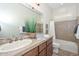 Bathroom featuring double sinks, decorative plants, and a shower-tub combo at 13353 W Gloria Ln, Peoria, AZ 85383