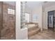 Bathroom showcasing glass block window above the tub and a tile shower stall at 13353 W Gloria Ln, Peoria, AZ 85383