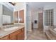 A bathroom featuring a tub, shower, and double sink vanity at 13353 W Gloria Ln, Peoria, AZ 85383