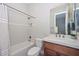 Well-maintained bathroom featuring a shower-tub combo and tiled vanity at 13353 W Gloria Ln, Peoria, AZ 85383