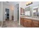 A bathroom featuring a double sink vanity, walk-in closet and tile floors at 13353 W Gloria Ln, Peoria, AZ 85383