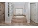 A spa bathroom featuring a walk-in shower and soaking tub with tile surround at 13353 W Gloria Ln, Peoria, AZ 85383