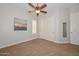 Neutral bedroom with fan, closet, and lots of natural light at 13353 W Gloria Ln, Peoria, AZ 85383
