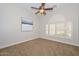 Inviting bedroom featuring a ceiling fan and a window with classic white shutters at 13353 W Gloria Ln, Peoria, AZ 85383