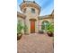Charming home courtyard with brick-paved flooring, potted trees, and the front door at 13353 W Gloria Ln, Peoria, AZ 85383