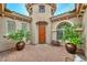 Charming courtyard featuring brick-paved flooring, potted trees, and the front door at 13353 W Gloria Ln, Peoria, AZ 85383