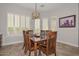 A dining room featuring a wooden table and chairs illuminated by a decorative chandelier at 13353 W Gloria Ln, Peoria, AZ 85383