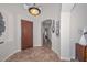 Inviting foyer features tile floors, an elegant light fixture and a view to an adjoining hallway at 13353 W Gloria Ln, Peoria, AZ 85383