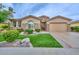 Charming single-story home featuring manicured lawn, stone accents, and attached two-car garage at 13353 W Gloria Ln, Peoria, AZ 85383