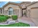 Inviting single-story home with stone accents, manicured lawn, and gated entryway at 13353 W Gloria Ln, Peoria, AZ 85383