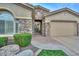Welcoming single-story home featuring stone accents, manicured lawn, and a two-car garage at 13353 W Gloria Ln, Peoria, AZ 85383