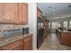 A kitchen featuring tile floors, a black refrigerator, and wood cabinets at 13353 W Gloria Ln, Peoria, AZ 85383