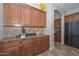 Granite counters and cabinetry details are showcased in this kitchen with tile flooring at 13353 W Gloria Ln, Peoria, AZ 85383