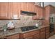 Well-appointed kitchen with granite counters, tile backsplash, and stainless steel appliances at 13353 W Gloria Ln, Peoria, AZ 85383