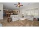 Bright living room showcases neutral decor, plantation shutters and open concept design at 13353 W Gloria Ln, Peoria, AZ 85383