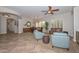 Open living and dining area with neutral color scheme, tile flooring, and ample natural light at 13353 W Gloria Ln, Peoria, AZ 85383